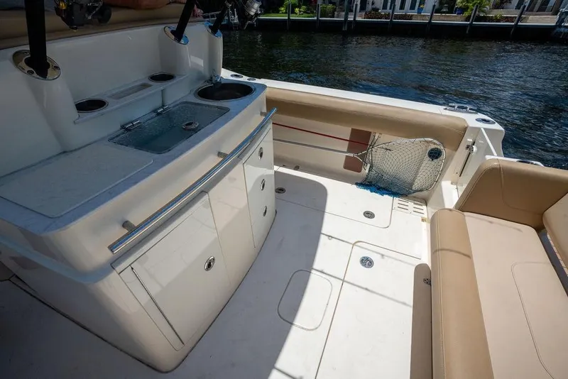 Slide: The Image of 2021 Scout 305 LXF boat interior with seating and fishing equipment. - 26