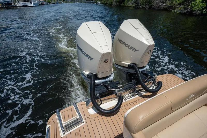 Slide: The Image of 2021 Scout 305 LXF boat with dual Mercury outboard engines on water. - 23