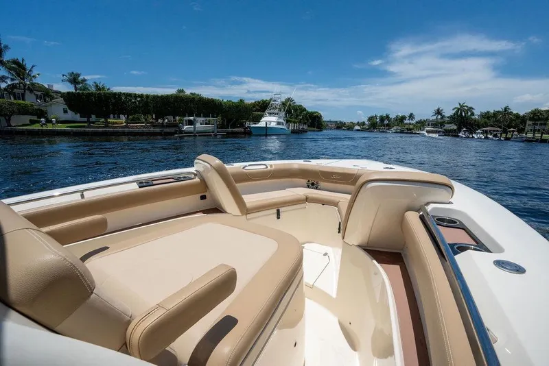 Slide: The Image of Luxurious 2021 Scout 305 LXF boat interior on a sunny day, cruising a scenic waterway. - 17