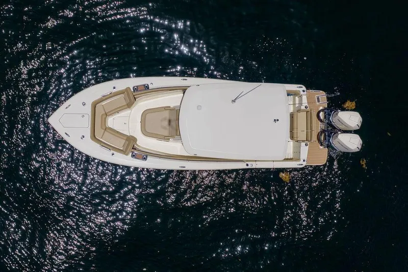 Slide: The Image of Overhead view of 2021 Scout 305 LXF boat on shimmering water. - 4