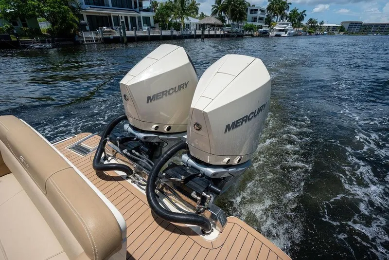 Slide: The Image of 2021 Scout 305 LXF boat with dual Mercury outboard engines on a sunny day. - 24