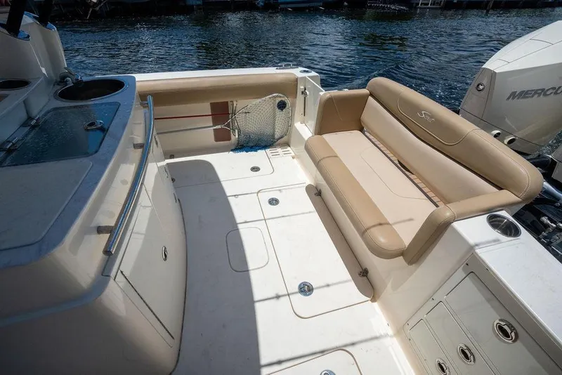 Slide: The Image of 2021 Scout 305 LXF boat interior with seating and fishing amenities. - 25