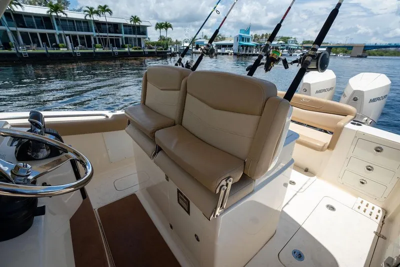 Slide: The Image of 2021 Scout 305 LXF boat interior with fishing rods and Mercury engines. - 30