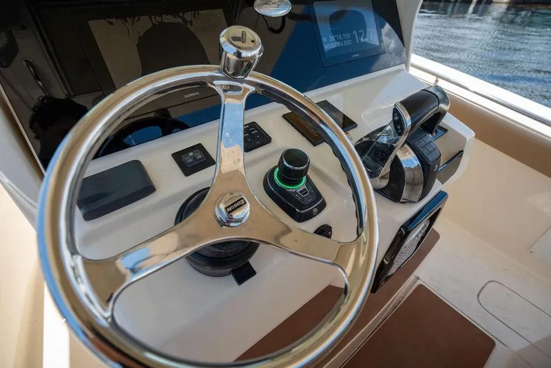 Slide: The Image of Steering console of 2021 Scout 305 LXF boat with modern controls and navigation system. - 32