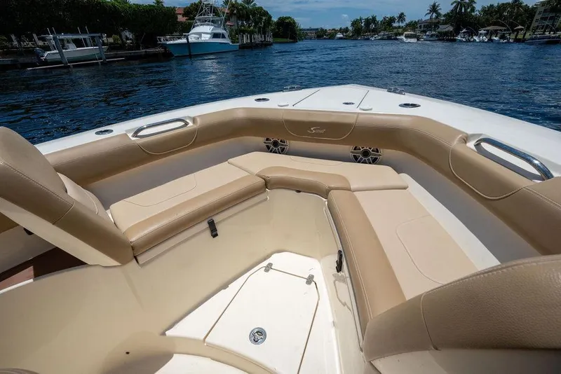 Slide: The Image of Luxurious seating on a 2021 Scout 305 LXF boat, cruising on a scenic waterway. - 18