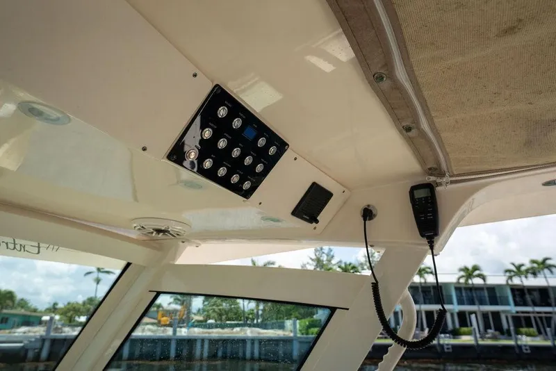 Slide: The Image of Interior view of 2021 Scout 305 LXF boat's control panel and radio system. - 34