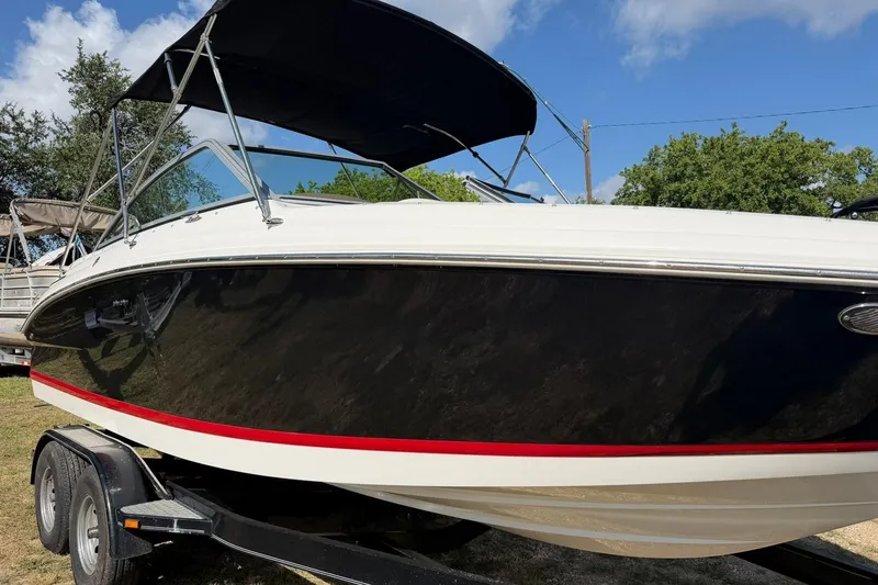 Slide: The Image of 2007 Cobalt 212 boat with black hull and red stripe on trailer. - 9