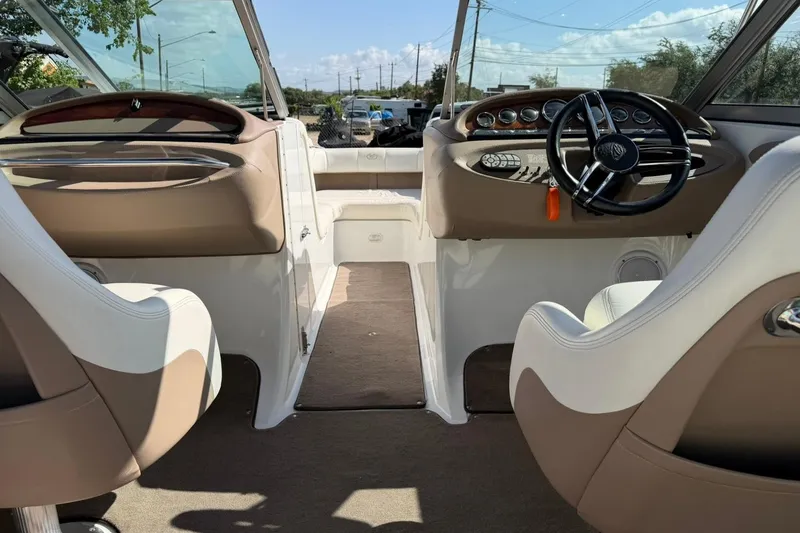 Slide: The Image of Interior view of a 2007 Cobalt 212 boat, featuring dual captain's chairs and a sleek dashboard. - 27