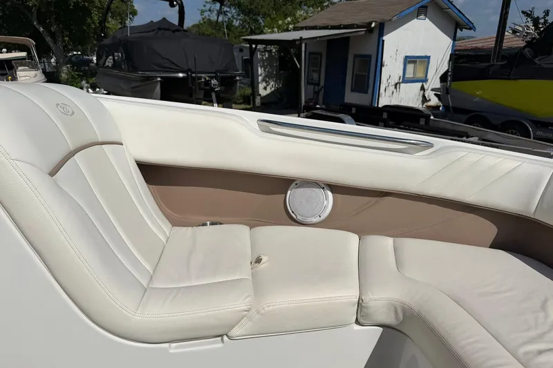 Slide: The Image of 2007 Cobalt 212 boat interior with white leather seating and speaker detail. - 44