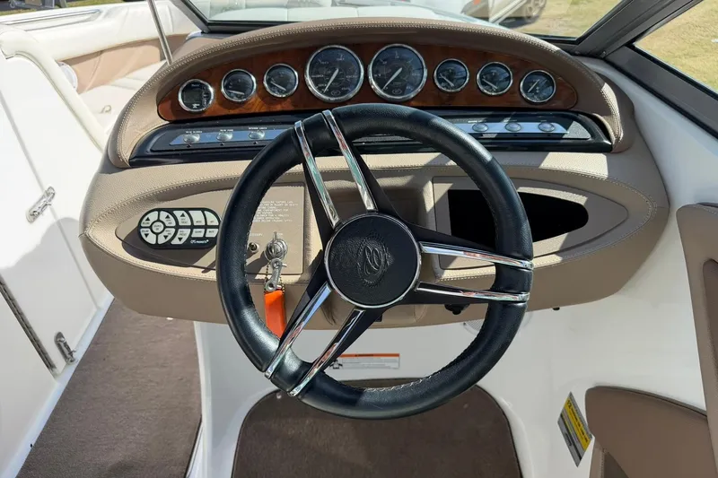 Slide: The Image of 2007 Cobalt 212 boat dashboard with steering wheel and instrument panel. - 35