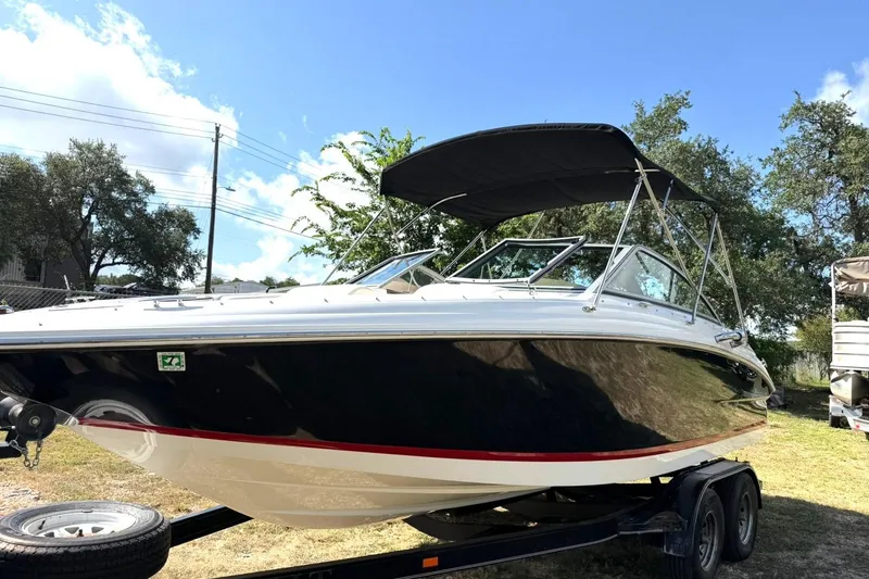 Slide: The Image of 2007 Cobalt 212 boat on trailer under clear blue sky. - 16