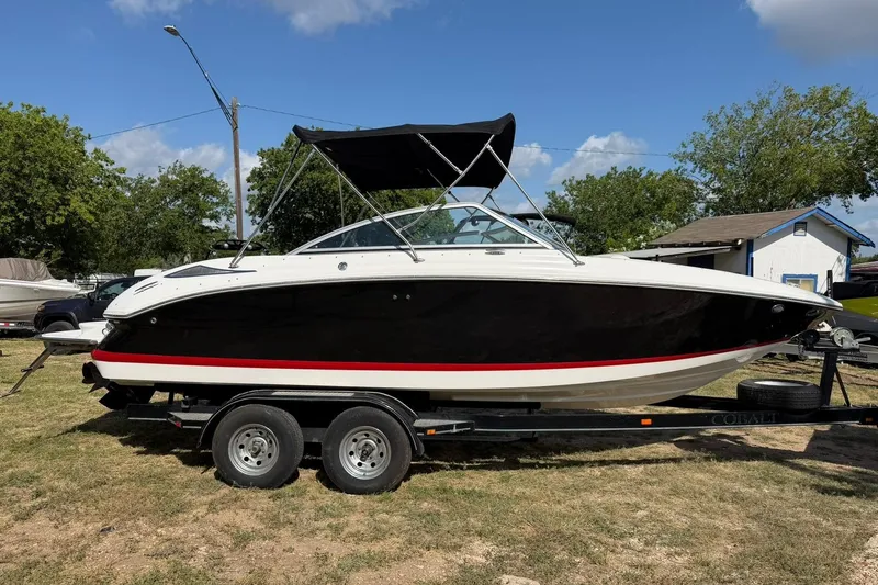 Slide: The Image of 2007 Cobalt 212 boat on trailer, black hull, red stripe, parked outdoors. - 6