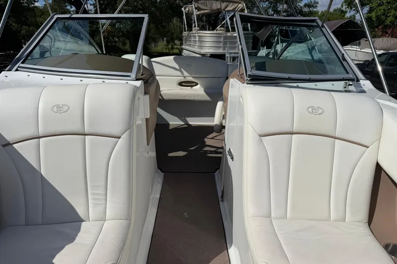 Slide: The Image of 2007 Cobalt 212 boat interior with white leather seats and open cockpit. - 46
