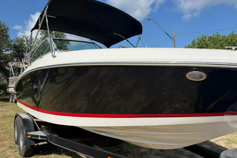 Slide: The Image of 2007 Cobalt 212 boat with black hull and red stripe on trailer. - 10