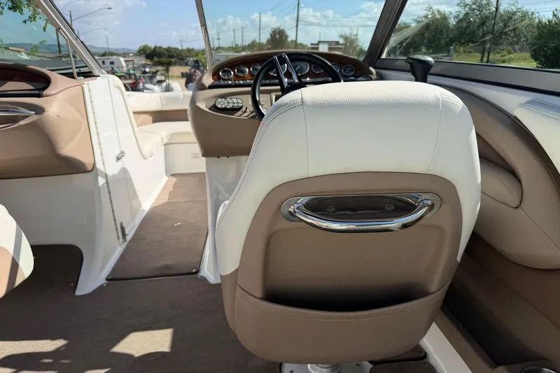 Slide: The Image of Interior of a 2007 Cobalt 212 boat, featuring beige and white seating. - 32
