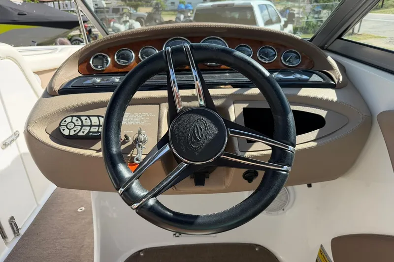 Slide: The Image of Steering wheel and dashboard of a 2007 Cobalt 212 boat, featuring gauges and controls. - 4