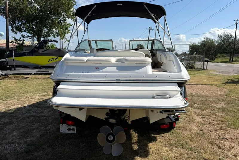 Slide: The Image of 2007 Cobalt 212 boat with canopy, parked on grass, rear view. - 20