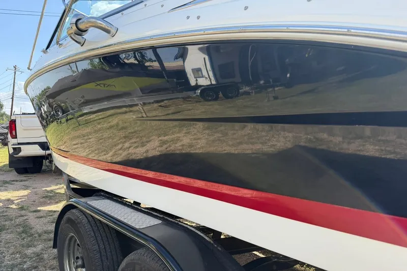 Slide: The Image of 2007 Cobalt 212 boat on trailer, featuring sleek black and white design with red accent stripe. - 19