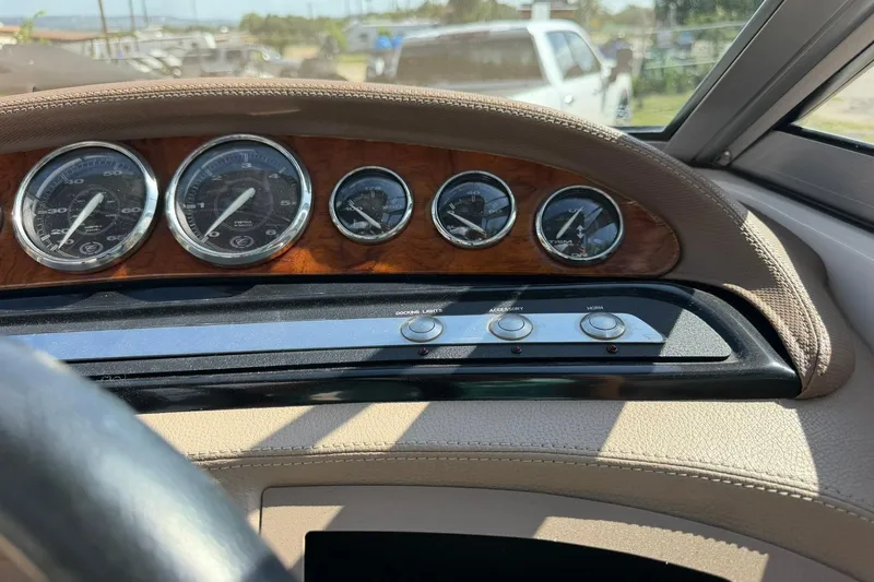 Slide: The Image of Dashboard of a 2007 Cobalt 212 boat with gauges and control buttons. - 36