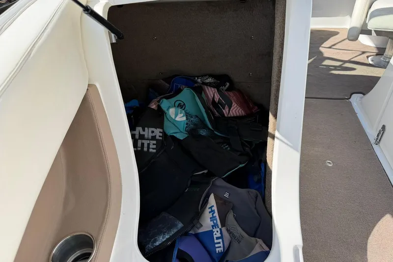 Slide: The Image of Storage compartment in a 2007 Cobalt 212 boat filled with life jackets. - 43