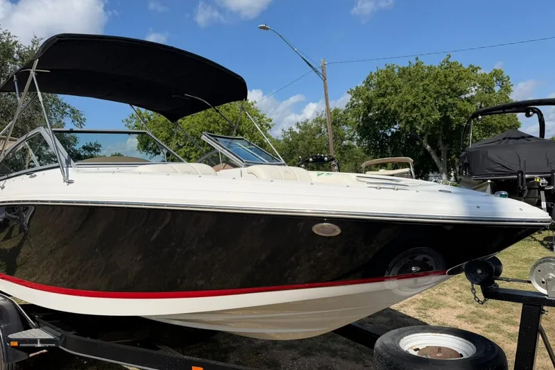 Slide: The Image of 2007 Cobalt 212 boat on trailer with black canopy, parked outdoors. - 8