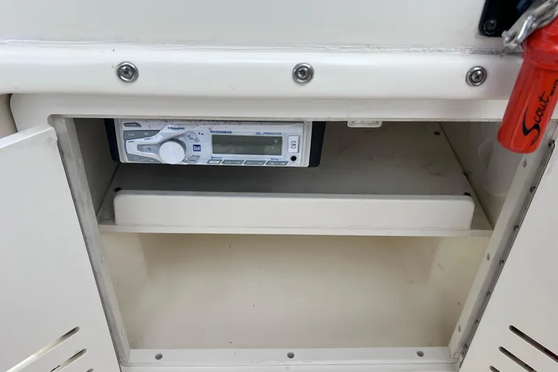 Slide: The Image of 2001 Scout 202 Dorado boat stereo system inside open compartment. - 30