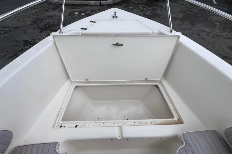 Slide: The Image of Open storage compartment on a 2001 Scout 202 Dorado boat deck. - 38