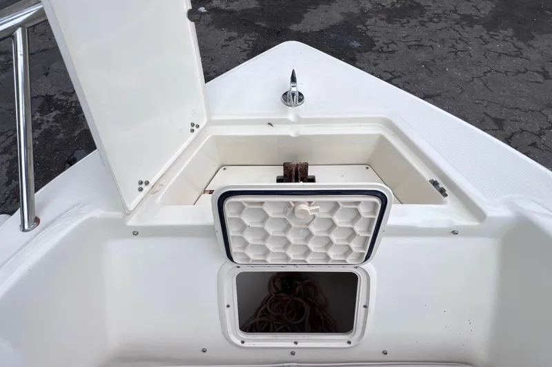 Slide: The Image of Open storage compartment on a 2001 Scout 202 Dorado boat deck. - 36