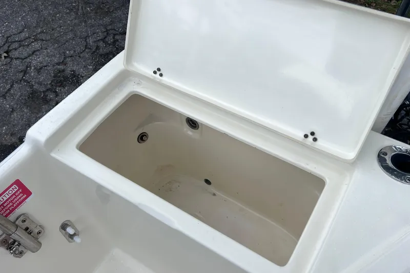 Slide: The Image of Open storage compartment on a 2001 Scout 202 Dorado boat, showing interior details. - 23