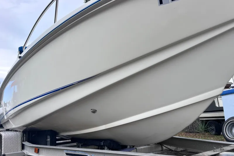Slide: The Image of 2001 Scout 202 Dorado boat on trailer, showcasing sleek hull design. - 2