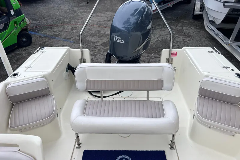Slide: The Image of 2001 Scout 202 Dorado boat interior with Yamaha 150 engine, featuring cushioned seating. - 15
