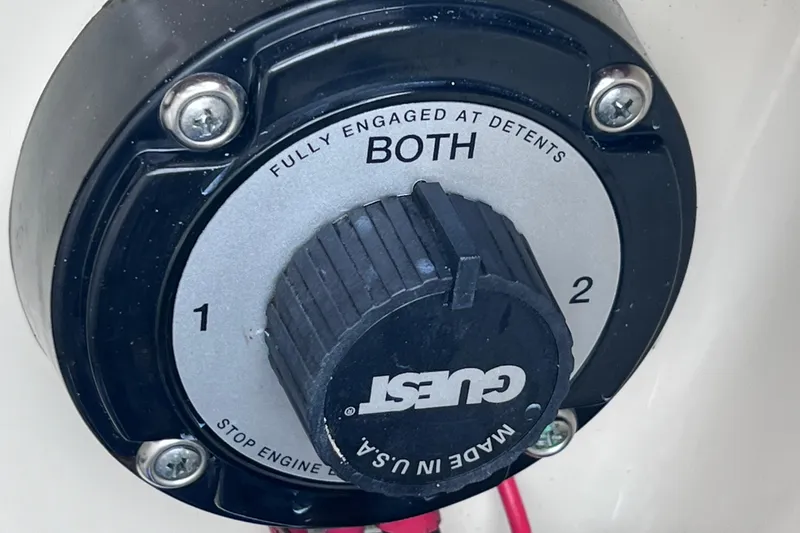 Slide: The Image of Battery selector switch on a 2001 Scout 202 Dorado boat, labeled "Guest" and "Both." - 20