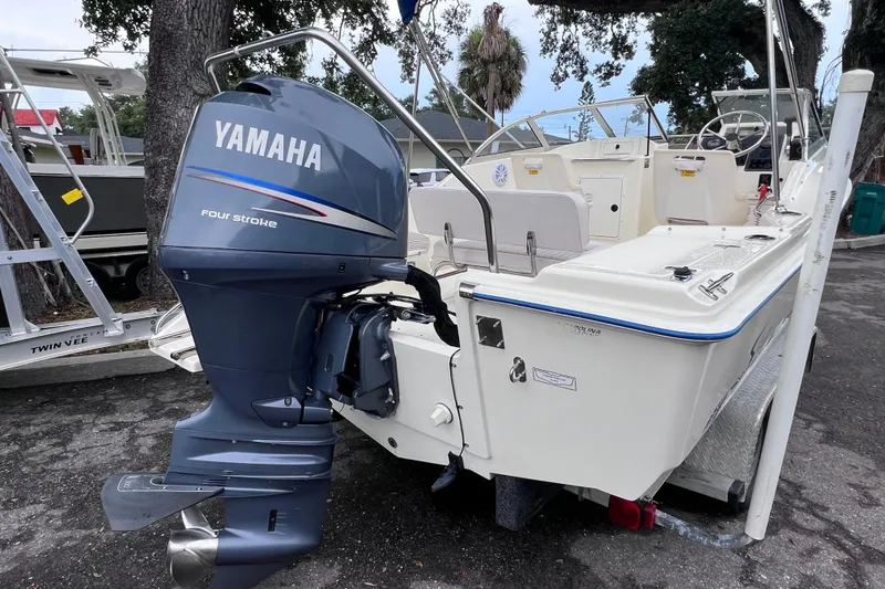 Slide: The Image of 2001 Scout 202 Dorado boat with Yamaha four-stroke outboard motor, parked outdoors. - 9