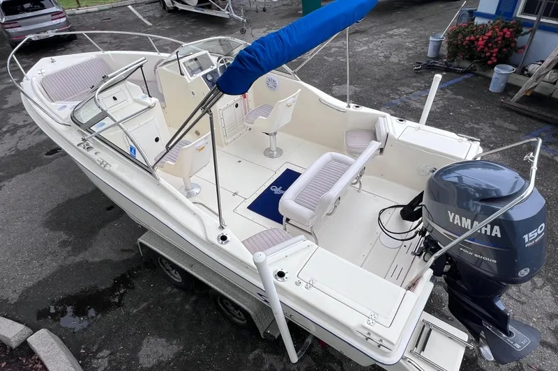 Slide: The Image of 2001 Scout 202 Dorado boat with Yamaha 150 engine, parked on a trailer. - 10