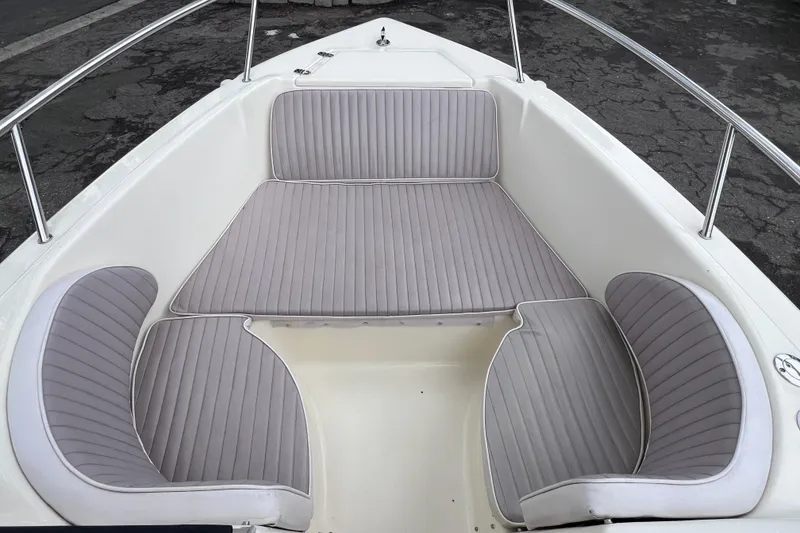 Slide: The Image of 2001 Scout 202 Dorado boat interior with gray cushioned seating and stainless steel railings. - 34
