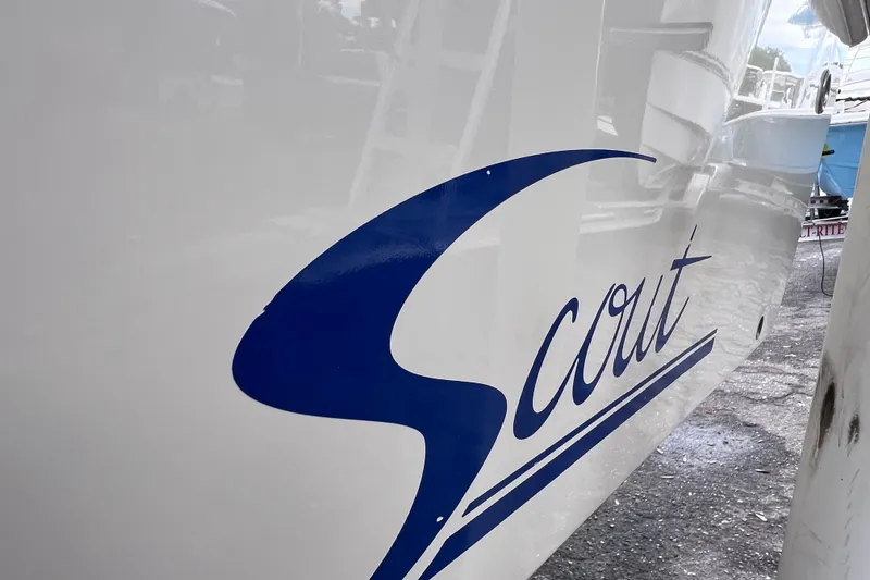 Slide: The Image of Close-up of 2001 Scout 202 Dorado boat logo in blue on white hull. - 7
