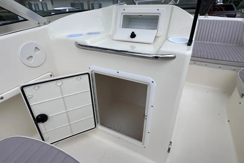 Slide: The Image of 2001 Scout 202 Dorado boat interior with open storage compartment and seating area. - 26