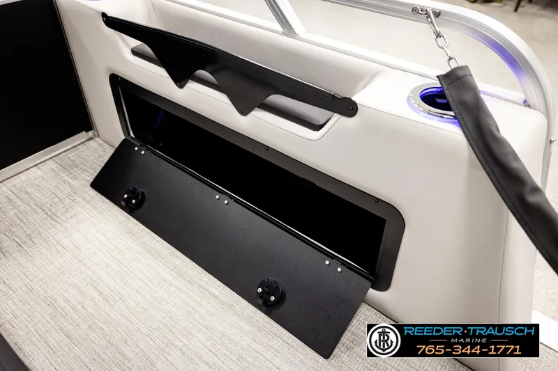 Slide: The Image of Interior of 2026 Avalon LSZ ENT boat with storage compartment and cup holder. - 34