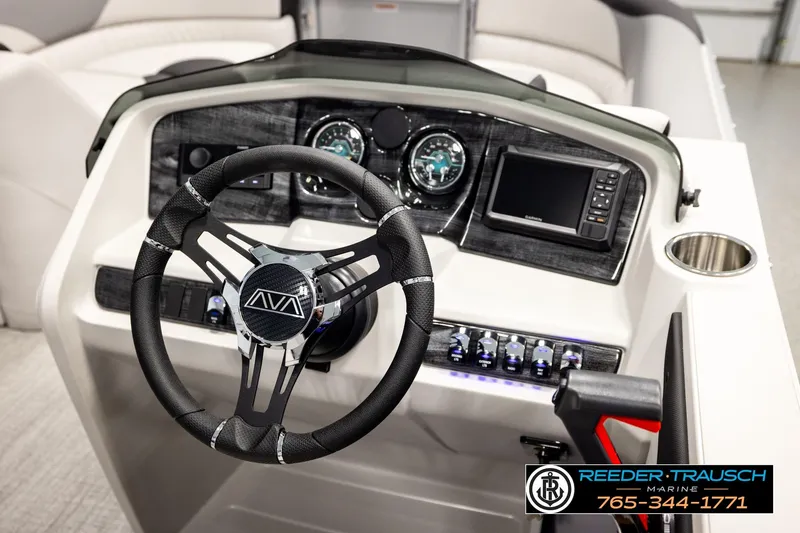 Slide: The Image of 2026 Avalon LSZ ENT boat dashboard with steering wheel, gauges, and navigation system. - 35