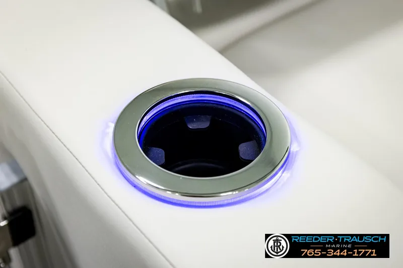 Slide: The Image of Illuminated cup holder on 2026 Avalon LSZ ENT boat, featuring sleek design and blue LED lighting. - 52