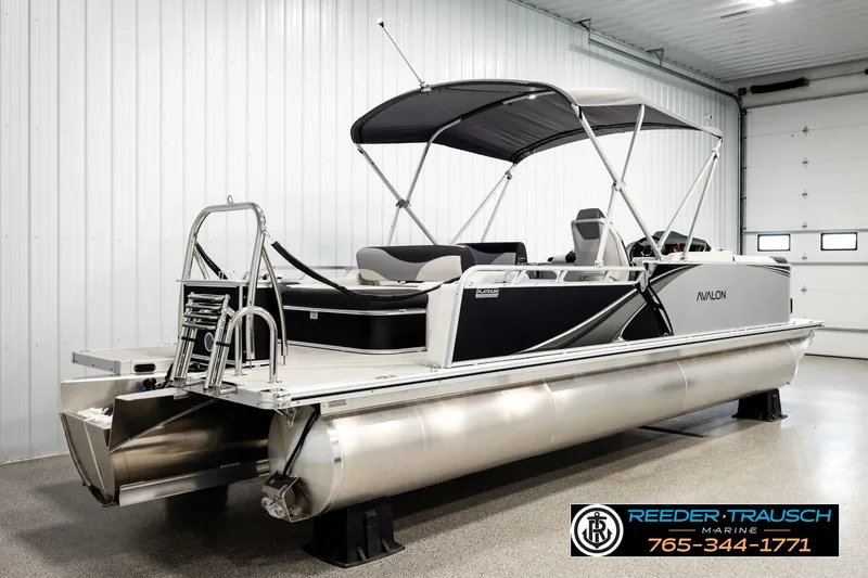 Slide: The Image of 2026 Avalon LSZ ENT pontoon boat in showroom, featuring sleek design and modern amenities. - 6