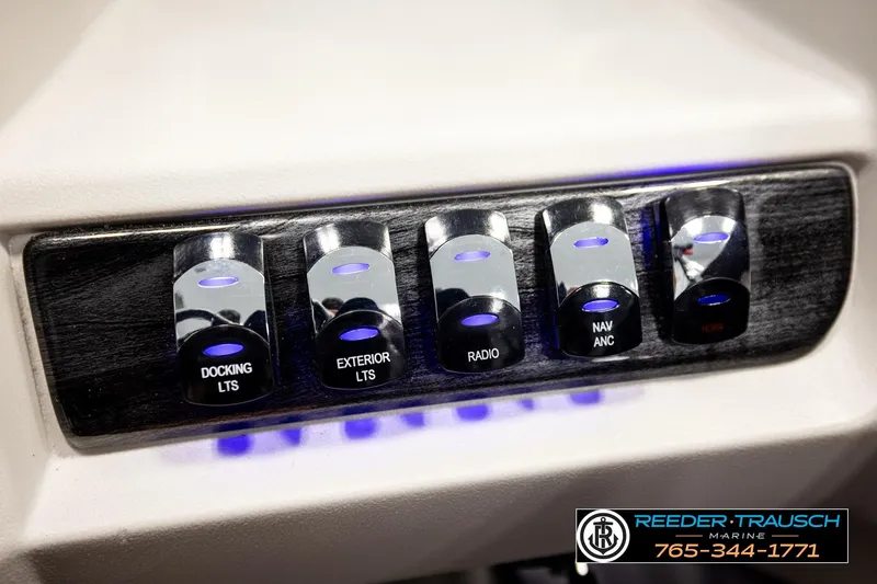 Slide: The Image of Control panel of 2026 Avalon LSZ ENT with illuminated switches for docking, exterior lights, and radio. - 43