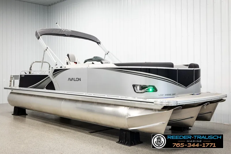 Slide: The Image of 2026 Avalon LSZ ENT pontoon boat in showroom, featuring sleek design and modern amenities. - 2
