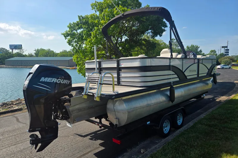 Slide: The Image of 2018 Sylvan Mirage Cruise 8522 LZ LE pontoon boat with Mercury engine by a lakeside. - 1
