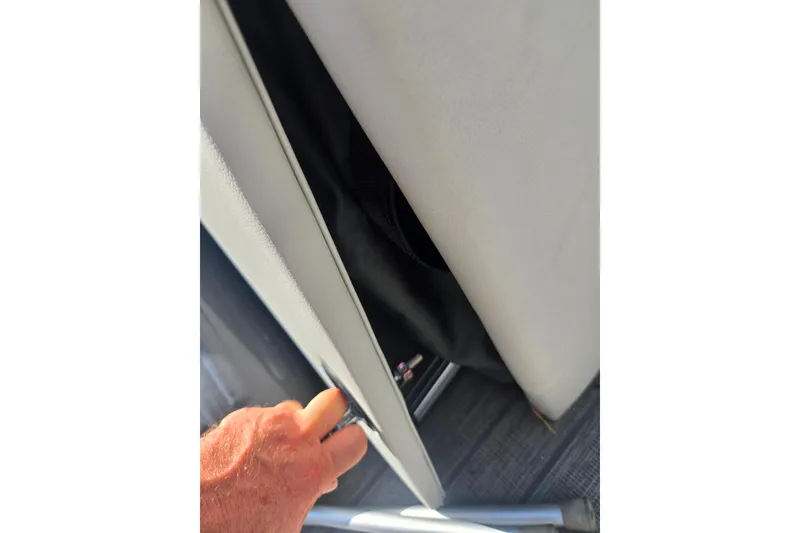 Slide: The Image of Hand opening storage compartment on 2018 Sylvan Mirage Cruise 8522 LZ LE boat. - 26