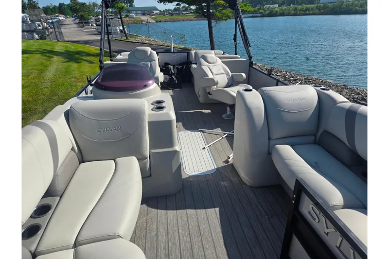 Slide: The Image of 2018 Sylvan Mirage Cruise 8522 LZ LE pontoon boat with spacious seating by a lake. - 12