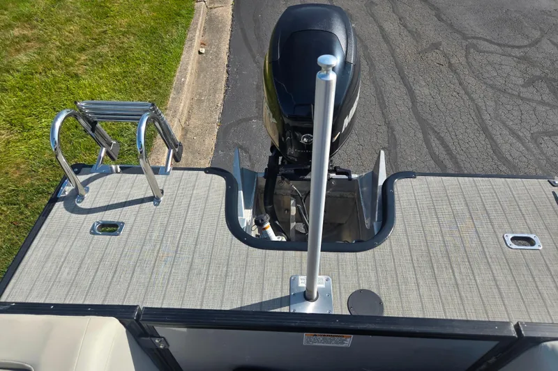 Slide: The Image of 2018 Sylvan Mirage Cruise 8522 LZ LE boat deck with motor and ladder. - 19