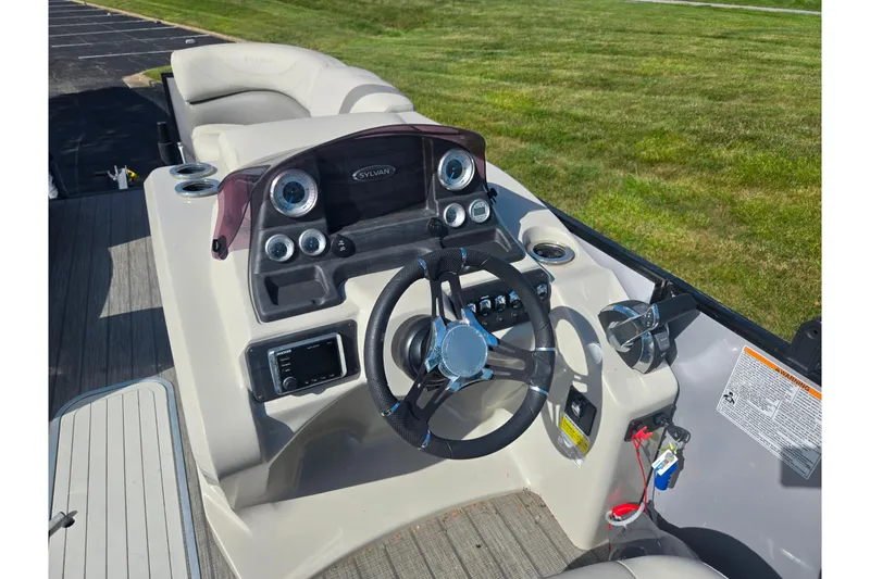 Slide: The Image of 2018 Sylvan Mirage Cruise 8522 LZ LE boat dashboard with steering wheel and controls. - 23