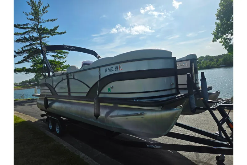 Slide: The Image of 2018 Sylvan Mirage Cruise 8522 LZ LE pontoon boat on trailer by a lake. - 9