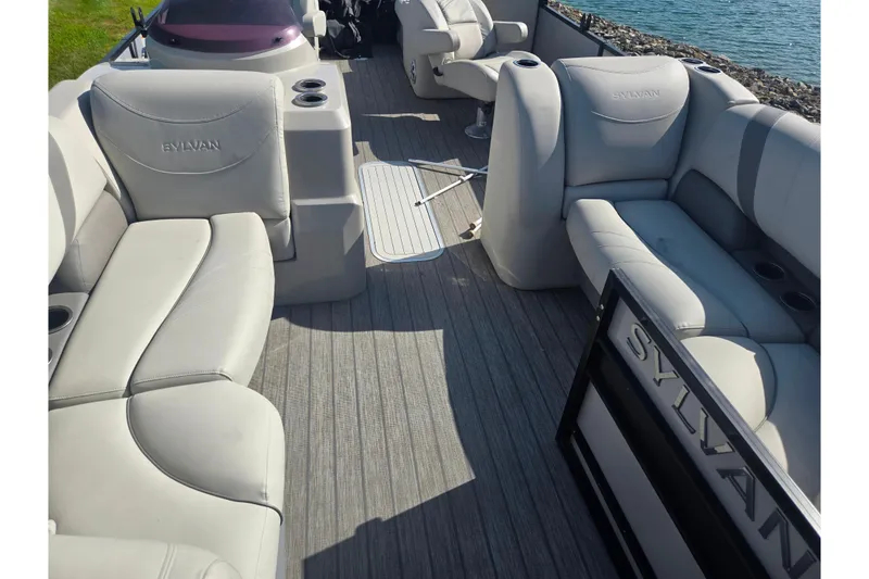 Slide: The Image of 2018 Sylvan Mirage Cruise 8522 LZ LE pontoon boat interior with plush seating and cup holders. - 11